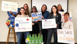 Several members of HPHC hold signs in support of zero waste policies that improve health while at the MN Zero Waste Coalition's legislative day.