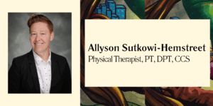 Allyson appears to be a young to middle-aged adult with light skin tone and bright red, short hair that's styled with volume. Allyson wears a black blazer with a white, polka dot collared shirt.